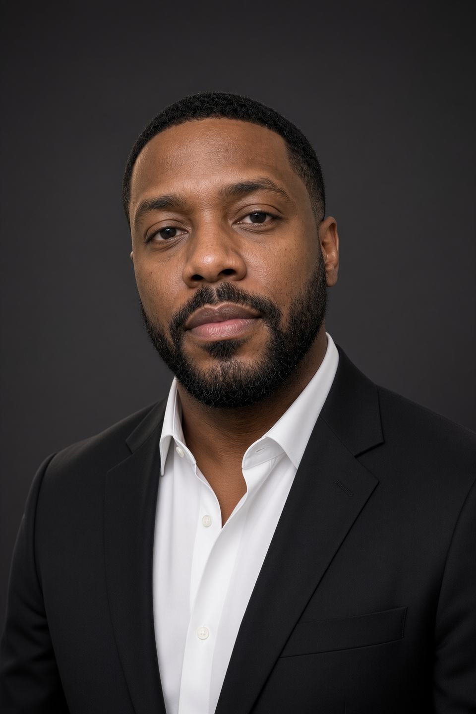 Executive headshot on a dark backdrop